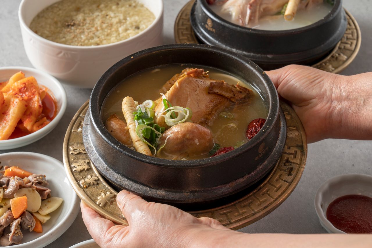  A man serve Samgyetang in hot bowl with rice