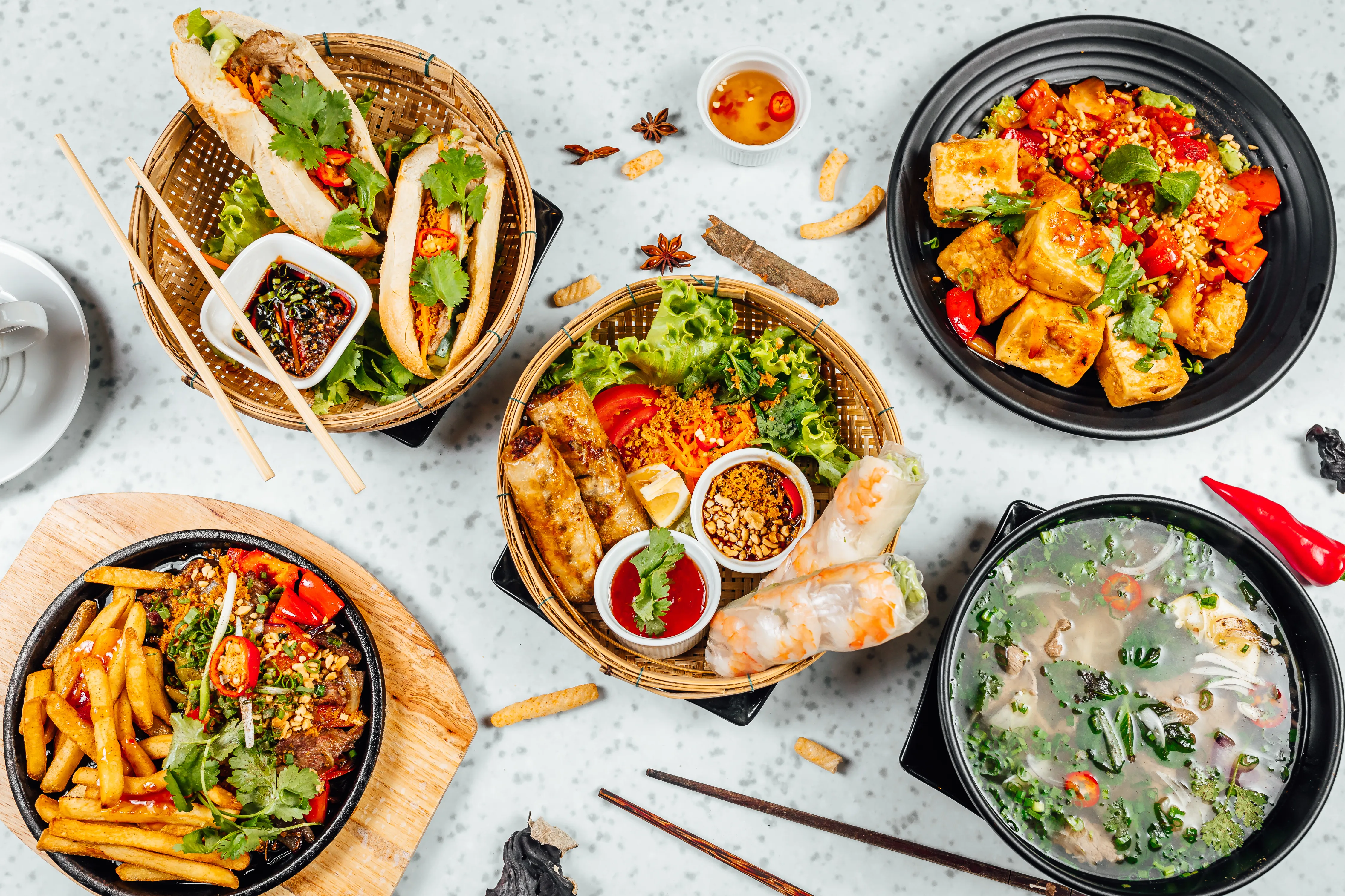 A wide variety of fresh and vibrant Vietnamese food on a table