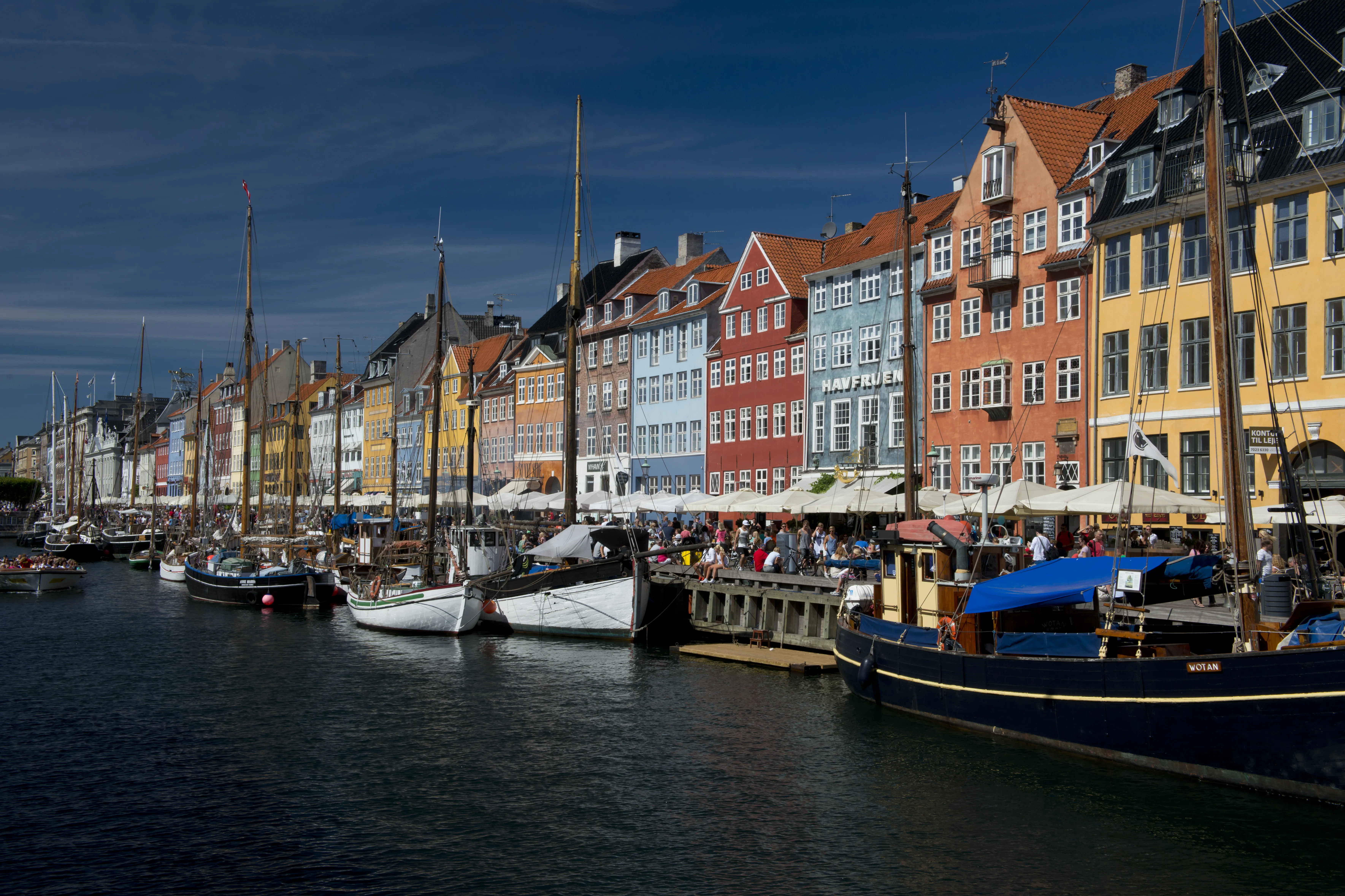 An evening view of buildings of Nyhavn in Copenhagen by the shore