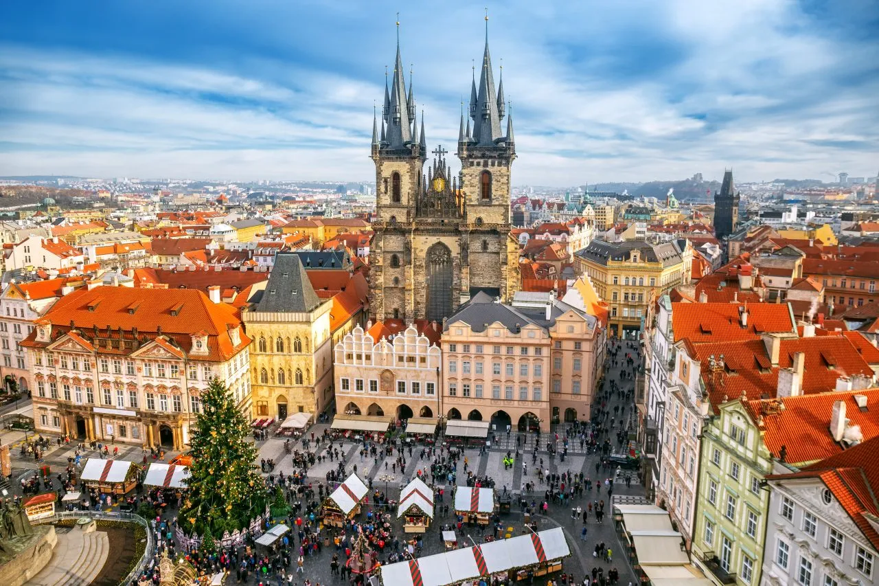 Aerial view of a European square with a Christmas market and a gothic church