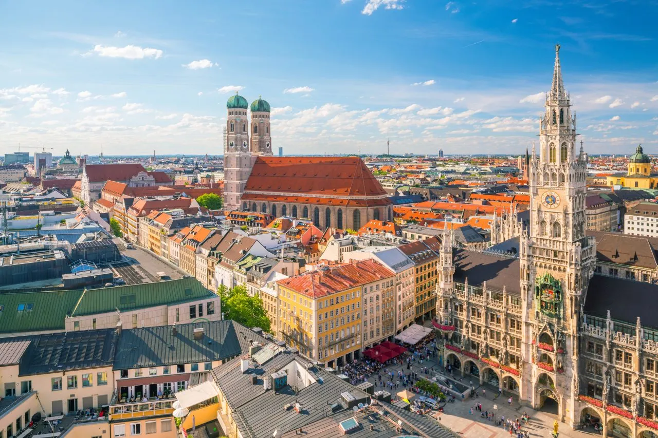 Cityscape with historic buildings, a large church, and a tall clock tower