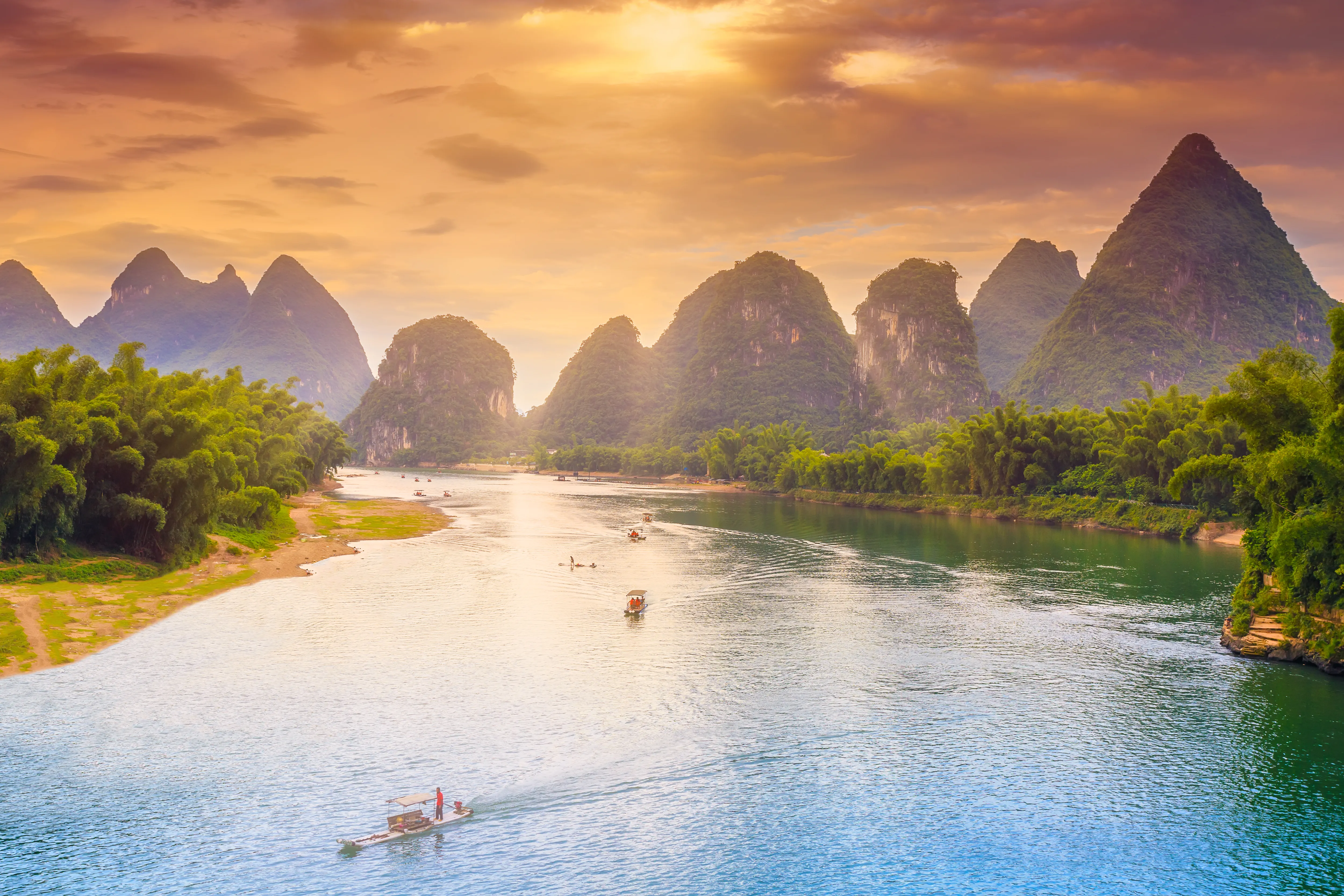 An eye-level, wide-angle shot of the Li River in Yangshuo, China