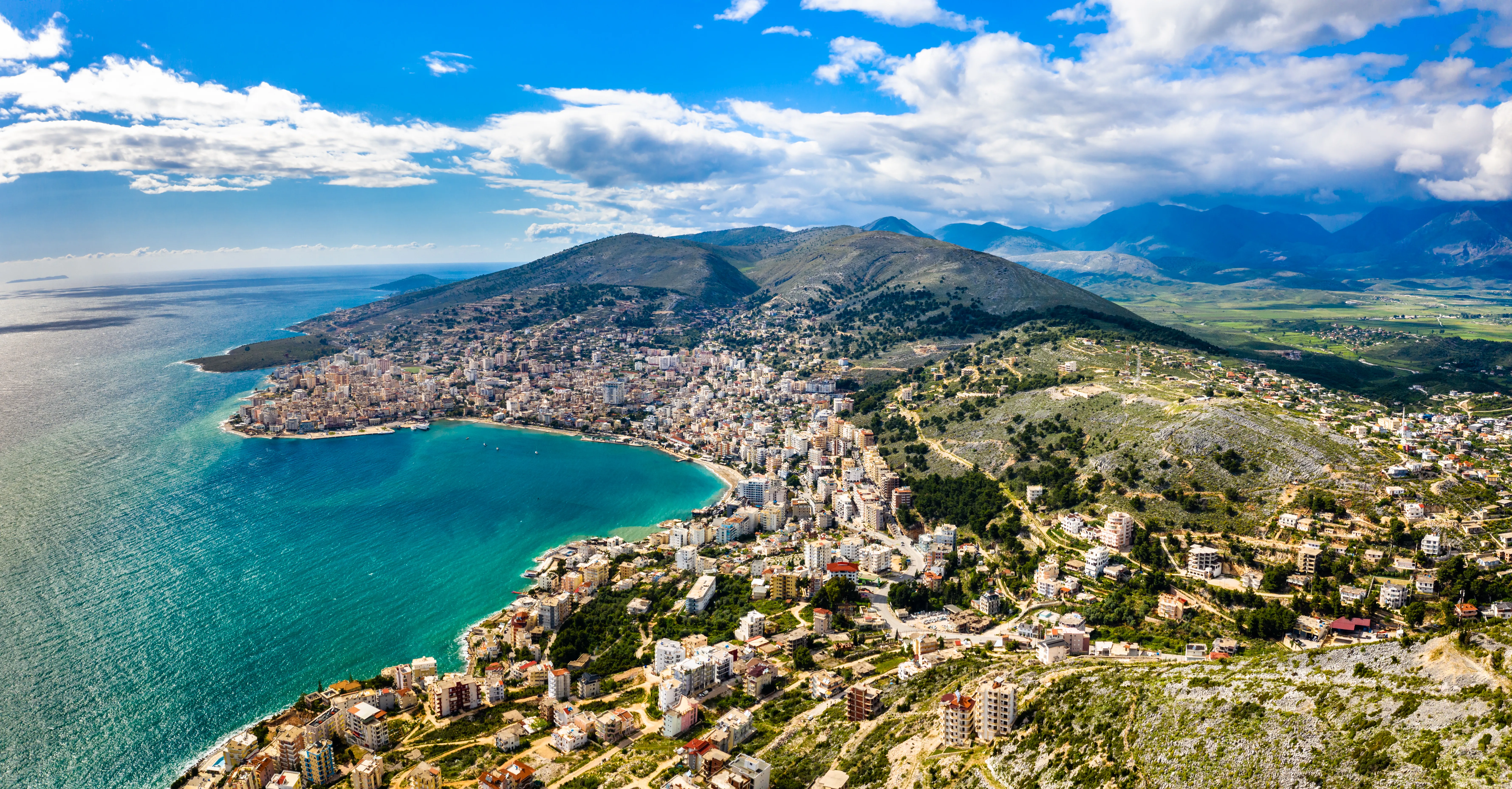 An aerial, high-angle panoramic shot of Sarandë, Albania