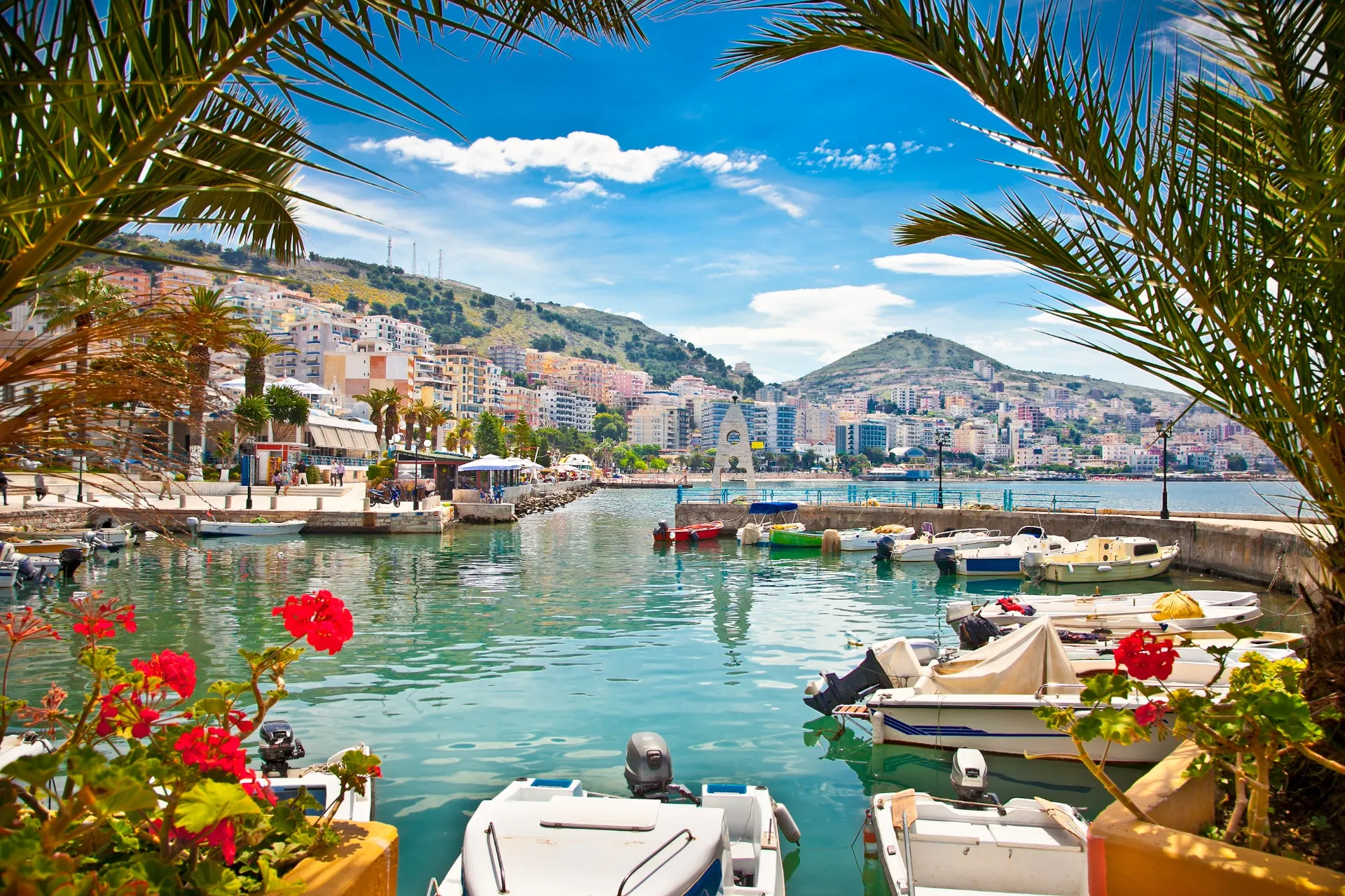 A wide-angle, eye-level shot of a scenic harbor in Sarandë, Albania