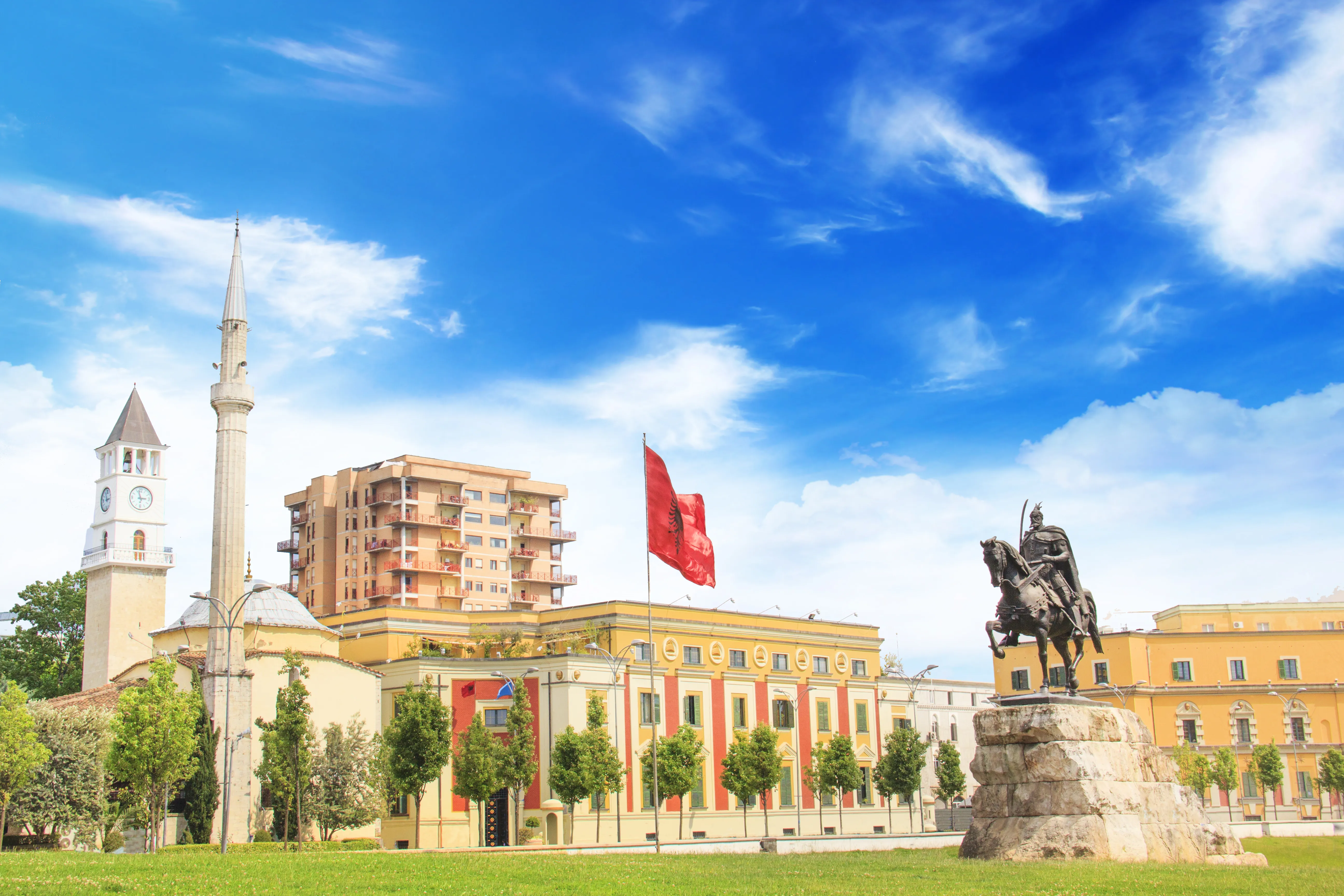 A low-angle, wide-angle shot of Skanderbeg Square in Tirana, Albania