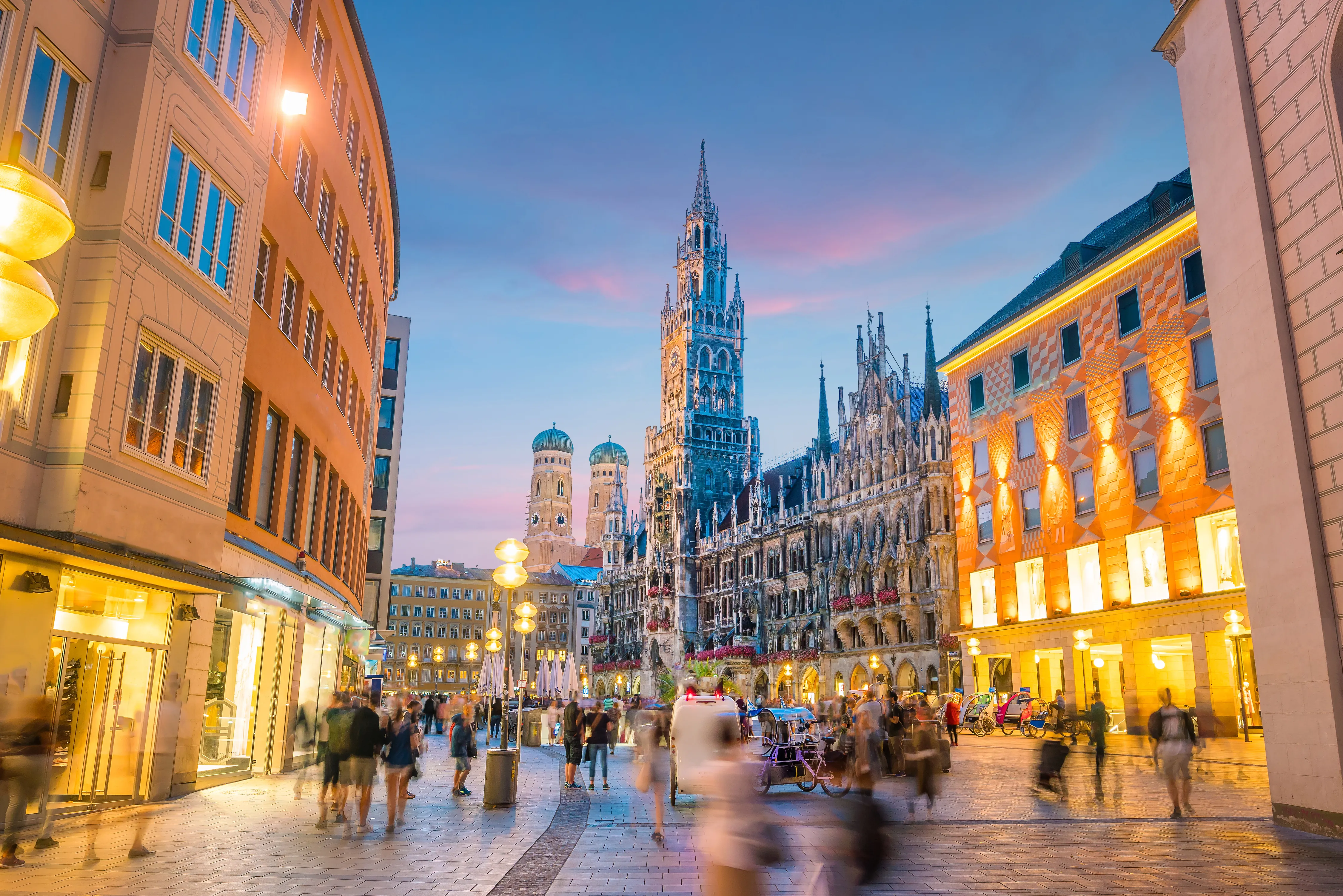 A low-angle, wide-angle shot of the bustling Marienplatz in Munich, Germany