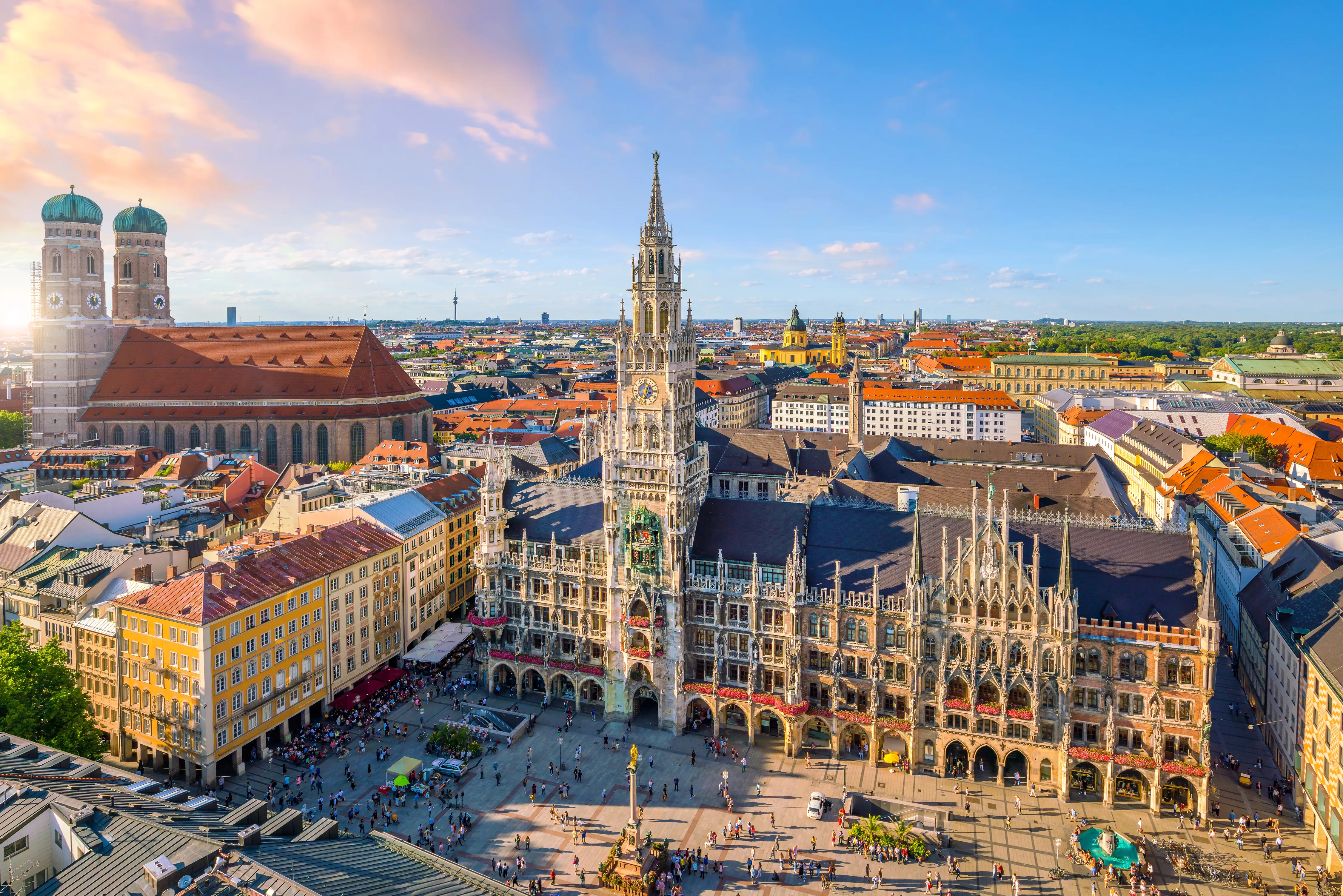 A high-angle, wide-angle panoramic shot looking down at Marienplatz in Munich, Germany