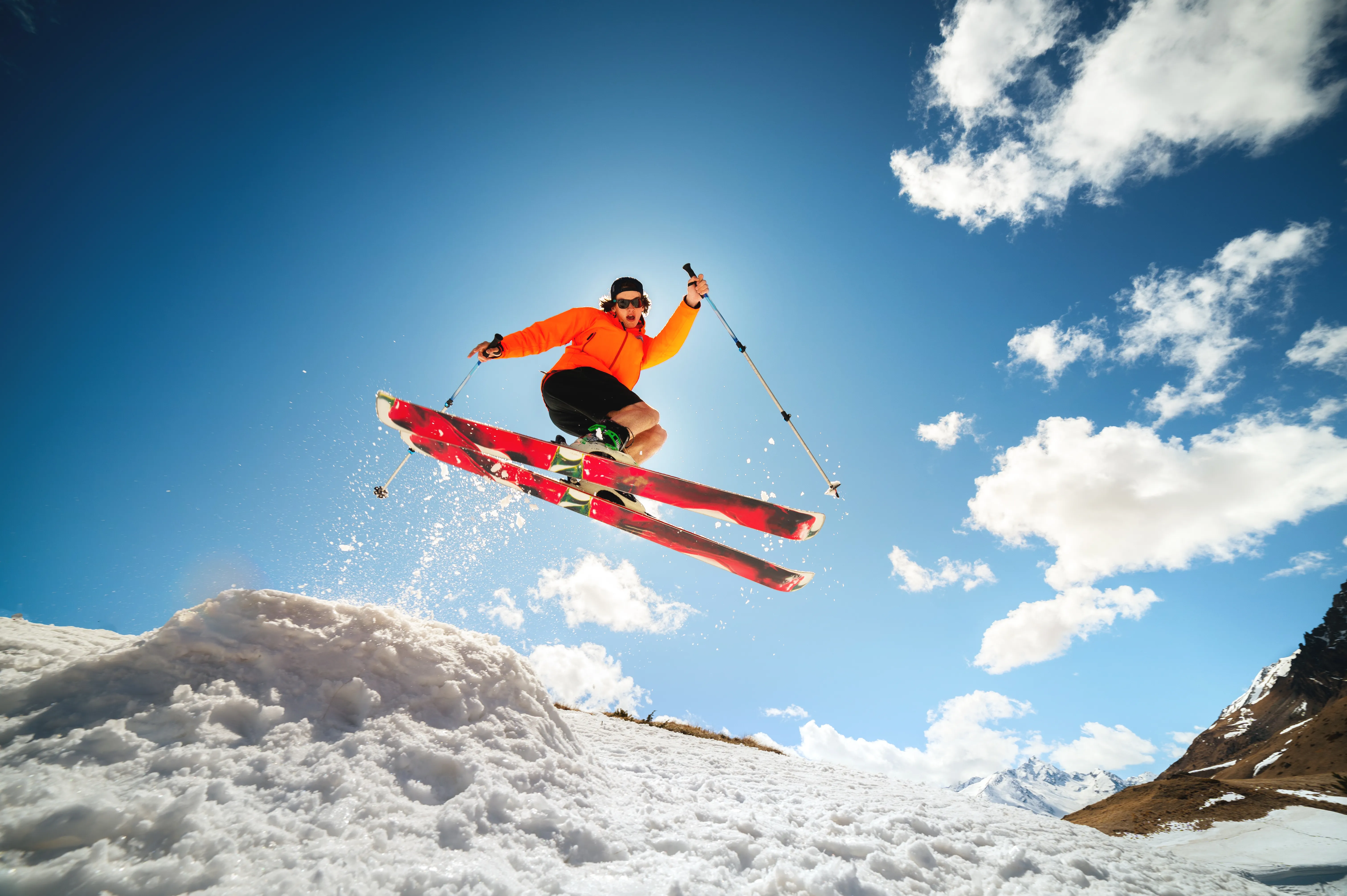Freestyle skier jumping over snowy slopes