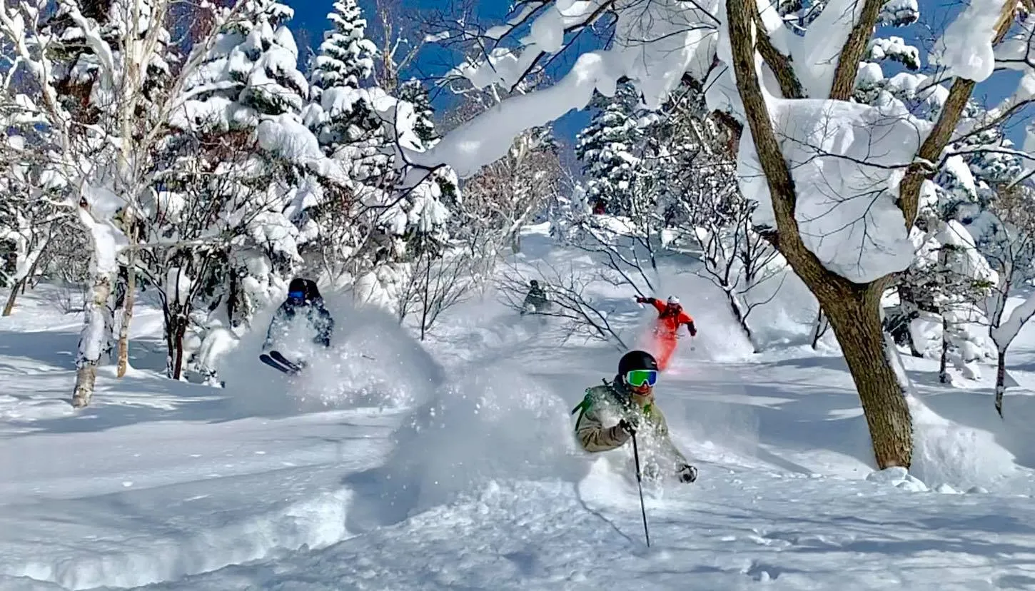  3 skiers going on a challenge in the Furano Ski Resort, Japan 