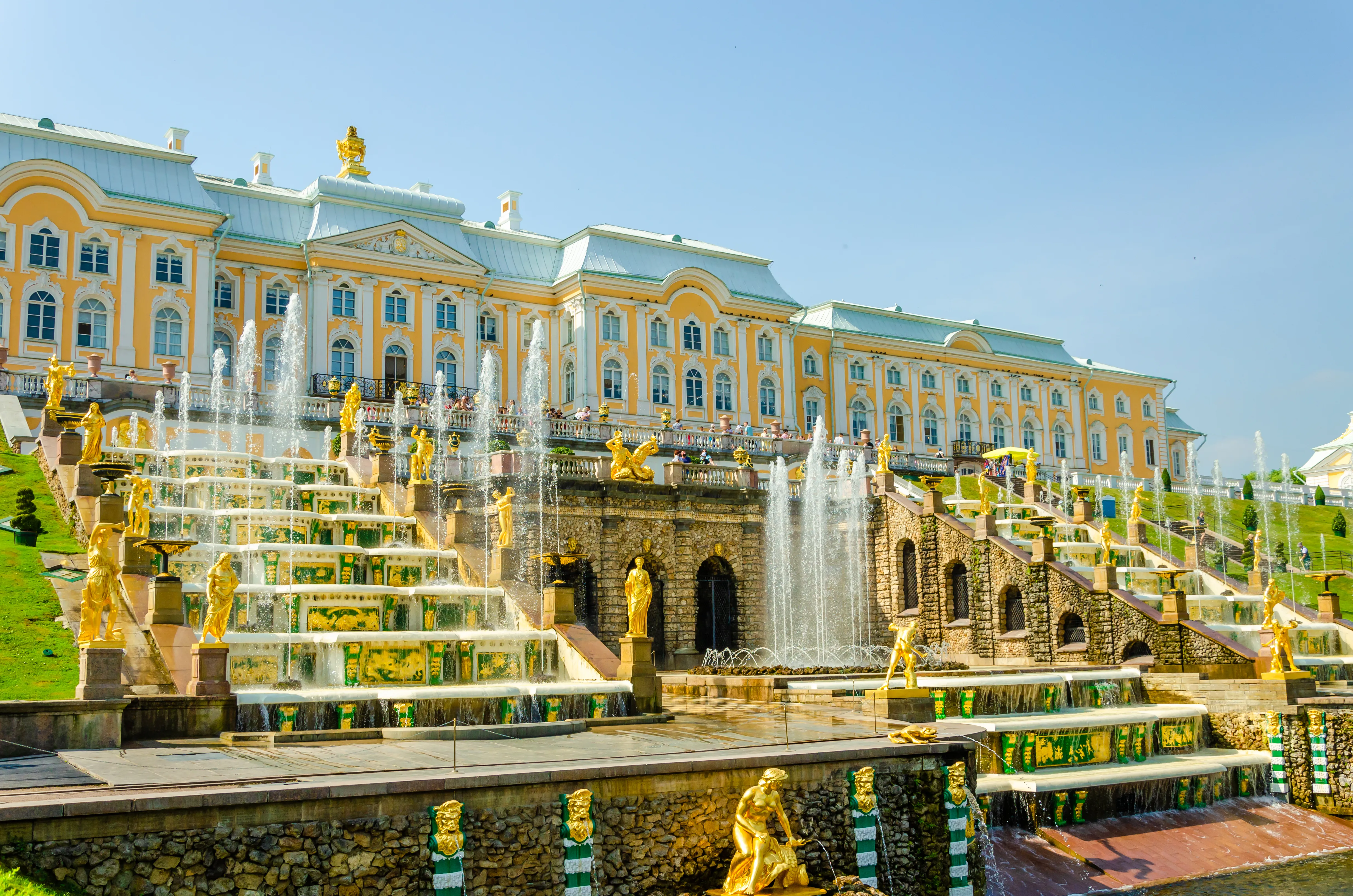 An architectural photograph shows the Grand Cascade and Grand Palace of Peterhof in Saint Petersburg, Russia
