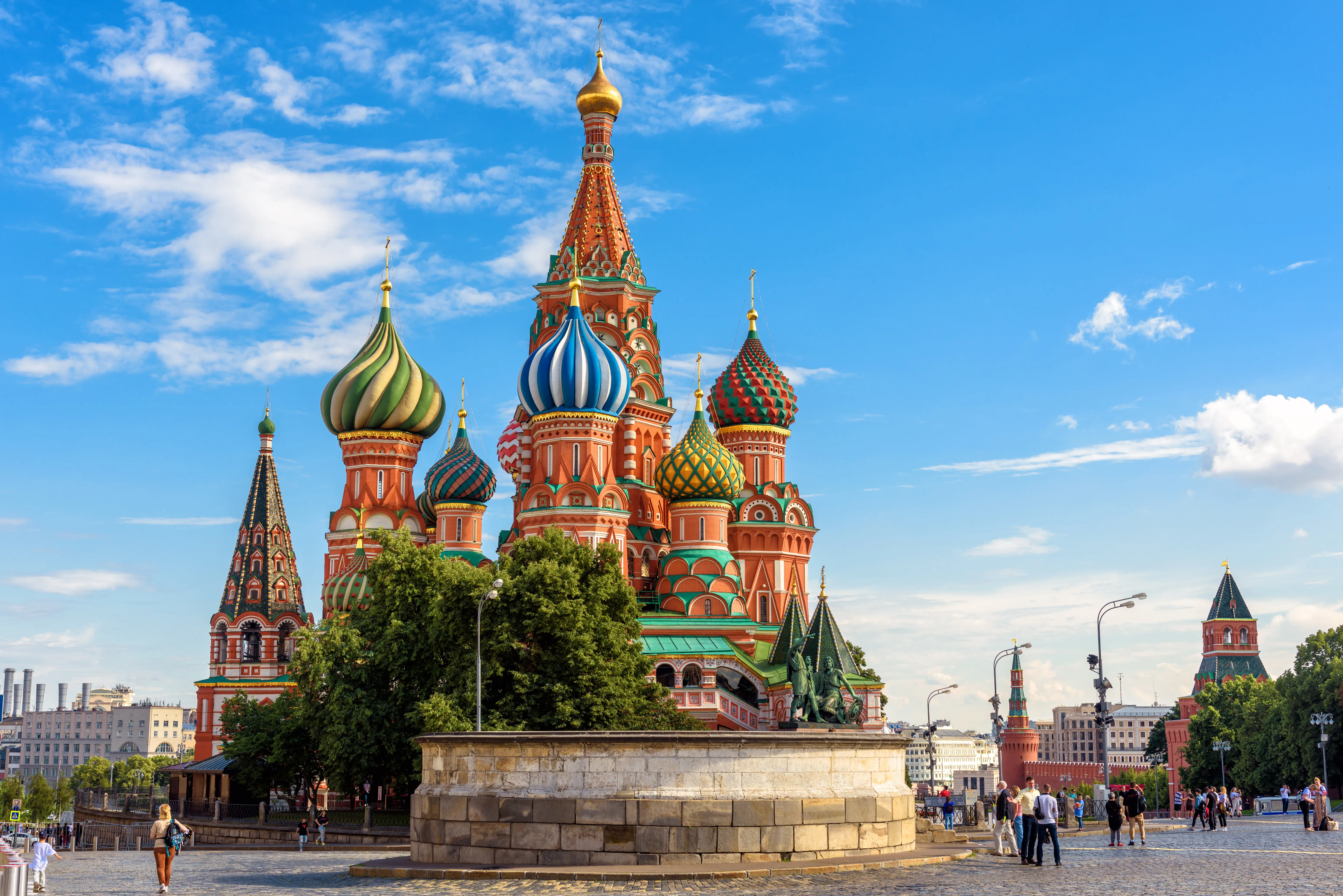 An architectural photograph shows Saint Basil's Cathedral at sunset in Red Square, Moscow, Russia.