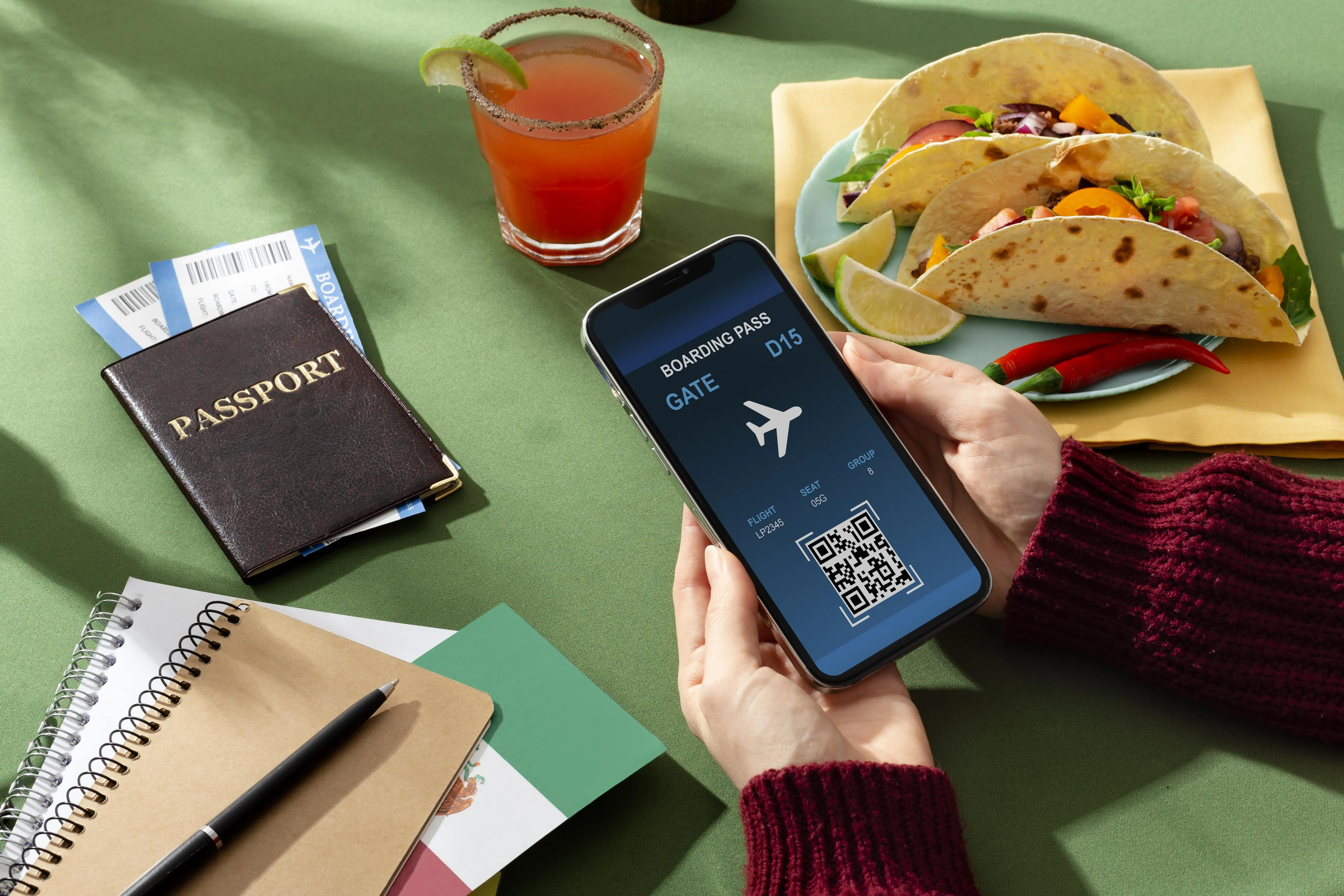 Hands holding a smartphone showing a digital boarding pass next to a passport and tacos