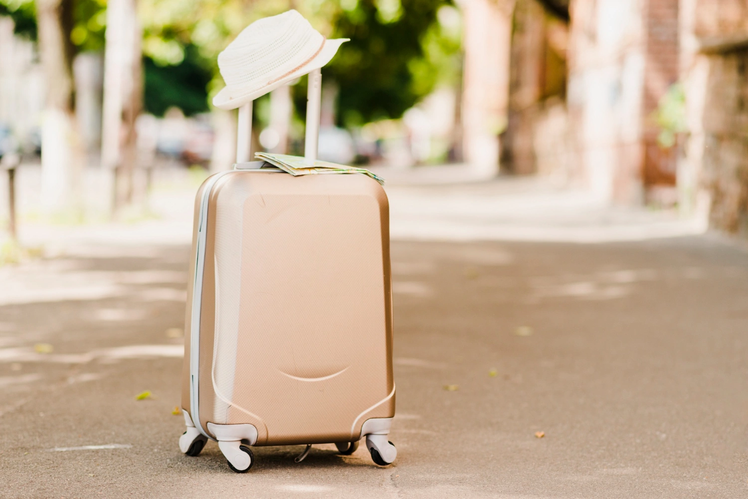 luggage-standing-on-a-sidewalk-with-hap-on-top
