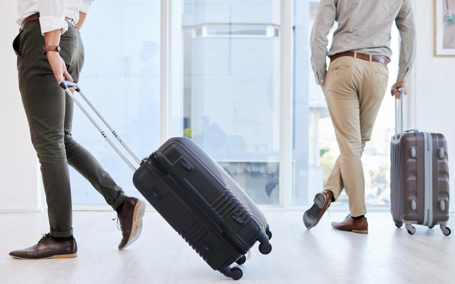 couple-holding-travel-luggages-at-the-airport